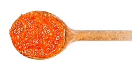 Paprika sauce in wooden spoon (Pesto alla calabrese) isolated on white, top view