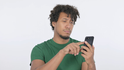 African Man Browsing Smartphone on White Background