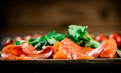 Pieces of salted salmon with parsley on the table. 
