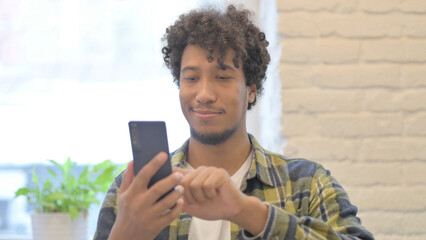 African Man using Smartphone for Browsing Internet