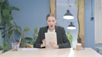 Shocked Businesswoman Reacting to Loss on Digital Tablet
