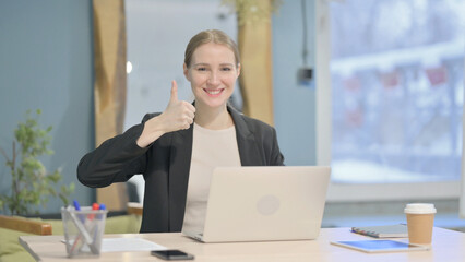 Fototapeta premium Thumbs Up by Businesswoman Working on Laptop
