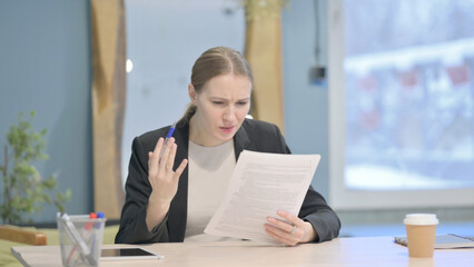 Businesswoman Feeling Upset after Reading Documents, Paperwork