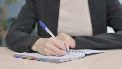 Close up of Businesswoman Writing in Office