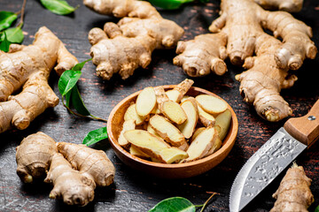 Pieces of fresh ginger on a wooden plate. 