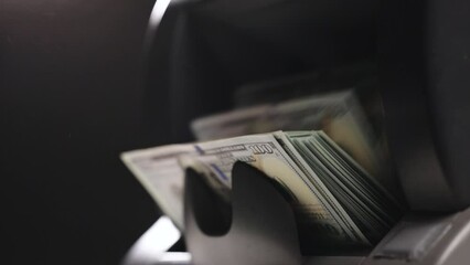 Machine counting money. Cash counting machine calculating 100 dollar bills. Closeup of bank automatic equipment for counting cash money. Currency exchange of one hundred dollar banknotes