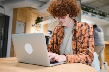 male programmer wear spectacles for eyes protection while working on freelance via laptop computer,clever student watching tutorial on netbook.