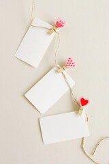Valentines Day blank papers, greeting cards mockup with hearst peg, clothespin hanging on a rope.