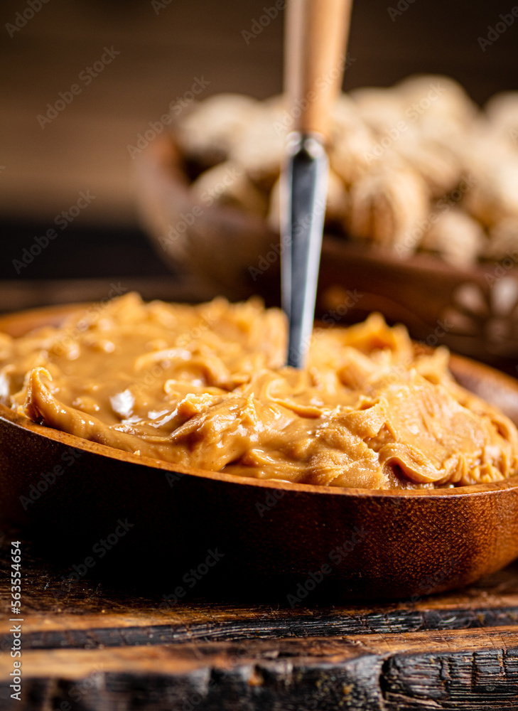 Canvas Prints Peanut butter on a plate with a spoon. 