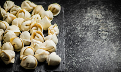 Raw dumplings on a stone board. 