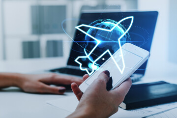 Businesswoman holding smartphone with digital interface with virtual globe