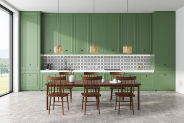 Stylish kitchen interior with eating table and chairs, cooking area and window