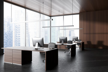 Grey business interior with pc computer and armchairs near panoramic window