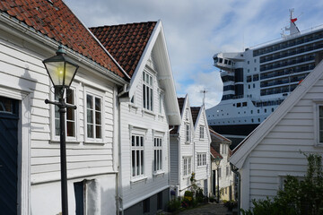 Cruise ship dwarfs the town of Stavanger , Norway 