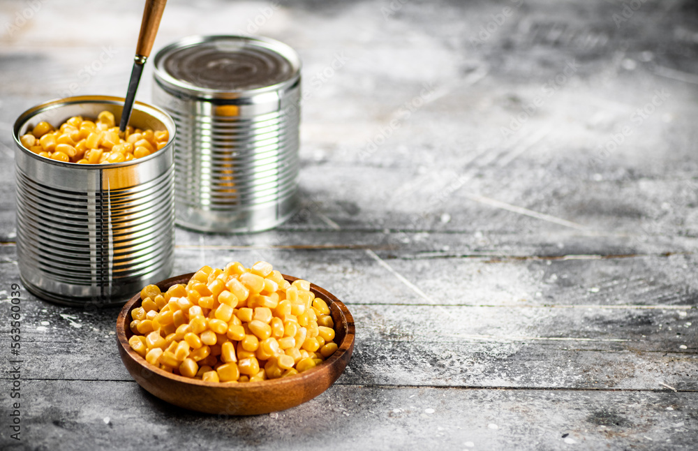 Poster Canned corn on a wooden plate. 