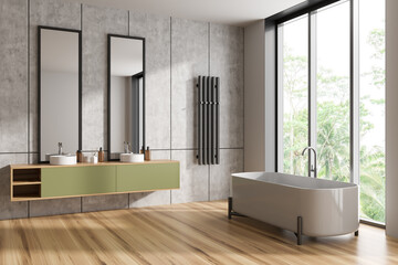 Modern bathroom interior with two washbasins and bathtub near window