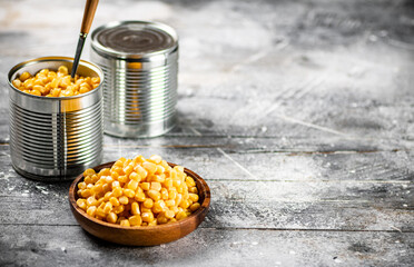 Canned corn on a wooden plate. 