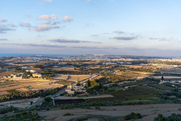 Sunny view at golden hour of surrounding fields from tower of Mdina