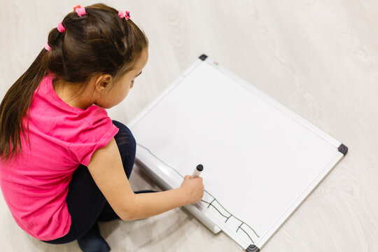 little girl writing on the white board, schooling background