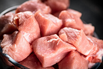 Raw pork sliced in a glass bowl. 