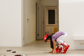 Caucasian little girl in roller skates standing at the living room