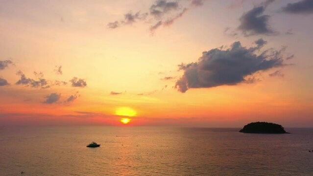 aerial view scenery sweet sky the sun down to the sea..beautiful sky at sunset in Kata beach Phuket Thailand.4k stock footage video in travel concept. cloud in sky background.