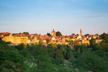 Panoramic aerial view of the town with green forest and sunlight background of Rothenburg in a beautiful summer day, Rothenburg Tauber is a city in the Franconia region of Bavaria, Germany.