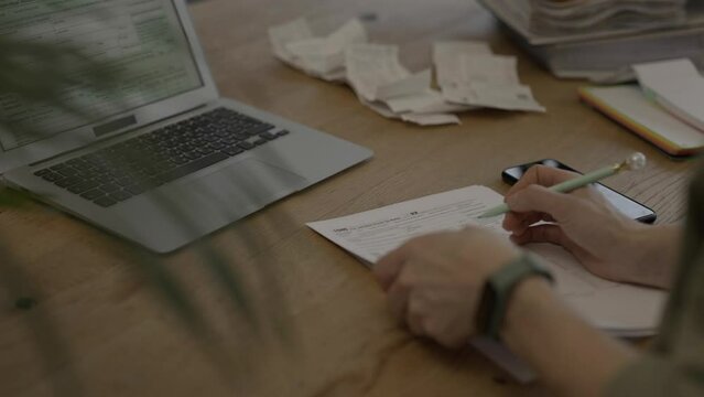 Female fills up the tax form at the table