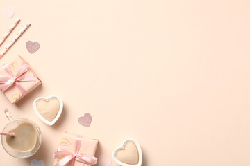 Happy Valentines Day flat lay composition. Top view gift boxes, heart-shaped coffee cup, candles on pastel beige background. Love, romance concept.
