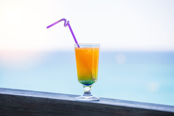 Summer cocktail on the beach with sea background. Selective focus.