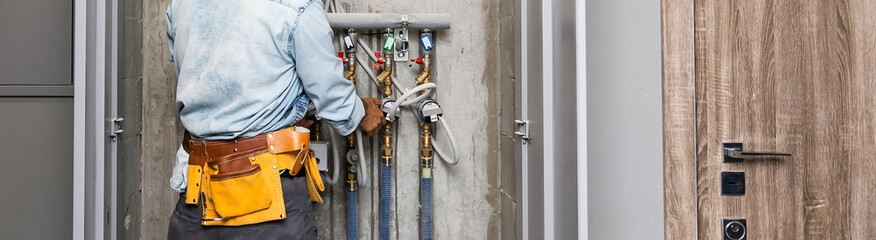 Fototapeta na wymiar Plumber Repairing Water Pipes In Residential Building