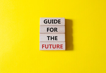 Guide for the future symbol. Wooden blocks with words Guide for the future. Beautiful yellow background. Business and Guide for the future concept. Copy space.