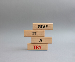 Give it a try symbol. Concept words Give it a try on wooden blocks. Beautiful grey background....