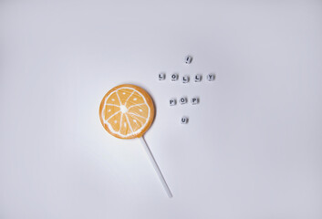 orange lolly pop with the text I lolly pop u spelled out with tiny blocks