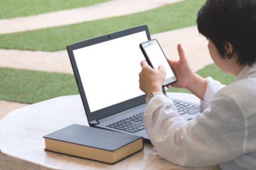 Woman using smartphone with laptop computer in front yard area at home, Transparent screen for your advertising text message or business content, png file