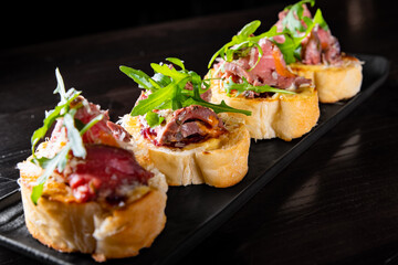 bruschetta with roast beef and cheese on plate