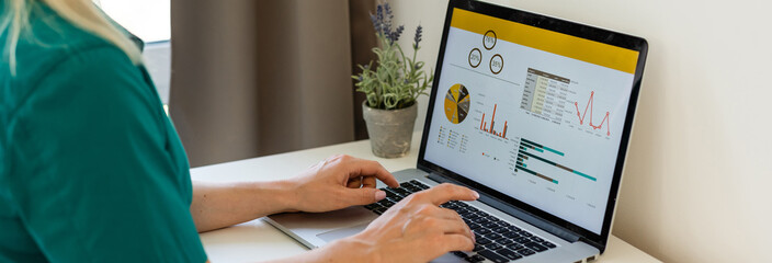 businesswoman analyzing statistics on laptop screen, working with financial graphs charts online, using business software for data analysis and project management concept, rear close up view - obrazy, fototapety, plakaty
