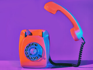 Vintage orange phone in neon light