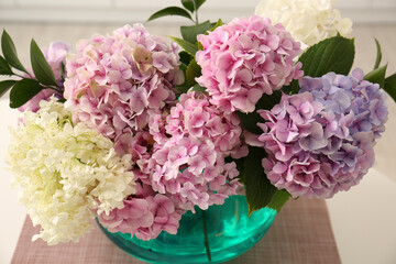 Bouquet of beautiful hydrangea flowers on table, closeup
