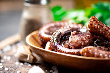 An octopus on a wooden plate. 