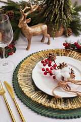 Luxury festive place setting with beautiful decor for Christmas dinner on white table, closeup