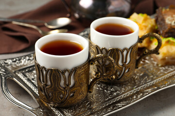 Tea served in vintage tea set on grey table, closeup