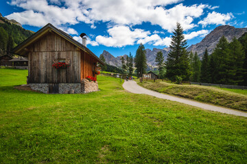 Cute wooden huts in the stunning San Nicolo valley, Dolomites