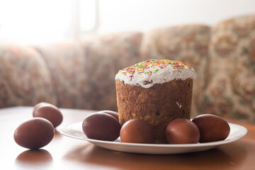 easter cake and red eggs on rustic wooden table. Top view.