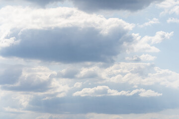 Blue sky and white clouds floated in the sky on a clear day with warm sunshine combined with cool breeze blowing against the body resulting in a miraculous refreshing like paradise.