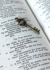 True security verses in open holy bible book and ancient key, a closeup. Christian biblical concept...