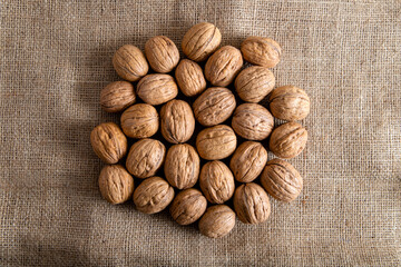 Whole shell walnuts on burlap sack,top view