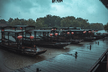 Old-fashioned cruises and the pier in the rain in South Lake in Jiaxing China