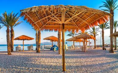Morning on sandy beach of Eilat - famous city with beautiful beaches and resort hotels , with thousands of vacationers and relaxing tourists from all around of the world.