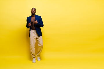 Fototapeta na wymiar Smiling young african american man guy isolated on yellow background studio. People sincere emotions